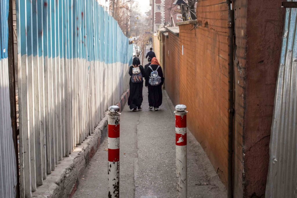 Two young women in an alley off Enghelab Street, Tehran, 2018 — from the Women in Public Space project