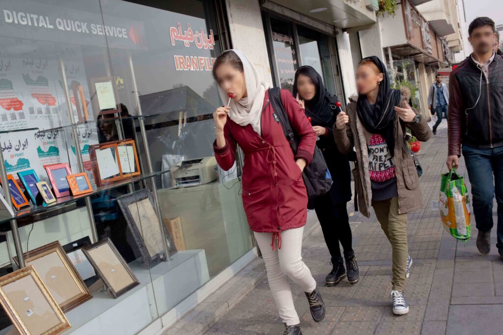 Group of young women in front of Film-e Iran photo shop, Enghelab Street, Tehran, 2019 — from the Women in Public Space project