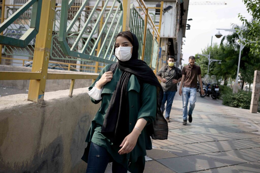Young woman wearing a mask at Valiasr–Enghelab intersection, Tehran, 2020–2021 — from the Women in Public Space project