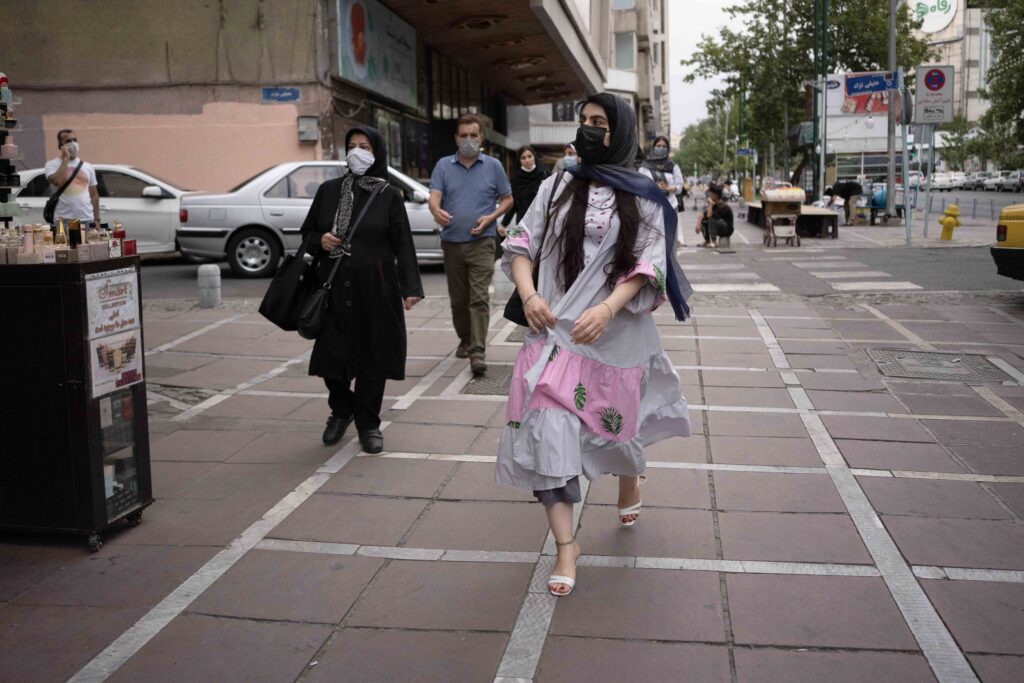 Young woman wearing a mask in front of Cinema Africa, Tehran, 2020–2021 — from the Women in Public Space project